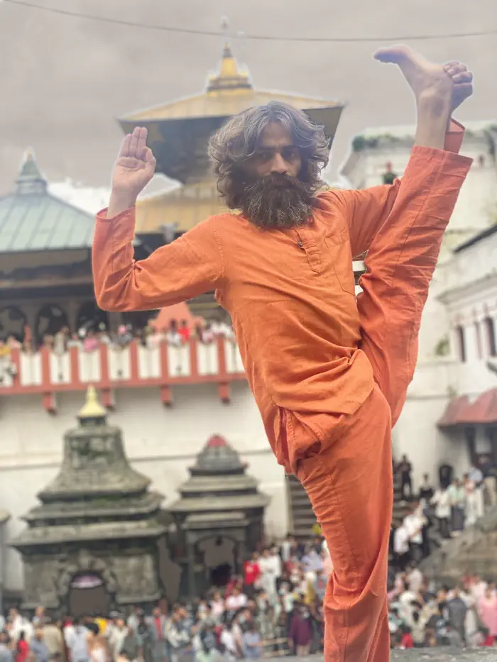Yogi Ji in a supported headstand on the paved courtyard at Pashupatinath.